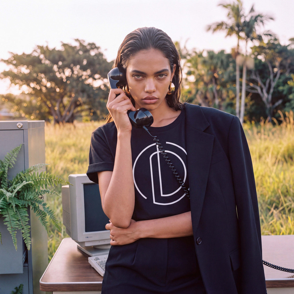 The AMAYA tee's rolled sleeve detail in black organic cotton – Oldest Daughter, Byron Bay