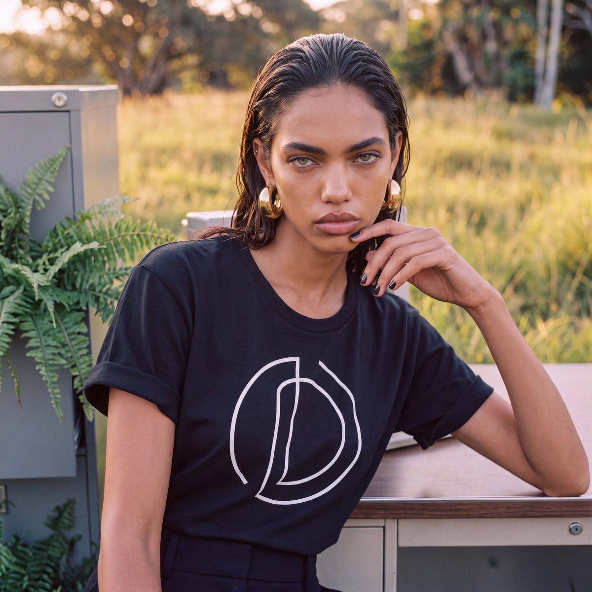 AMAYA relaxed rolled-sleeve tee in black organic cotton, hem detail – Oldest Daughter, Byron Bay
