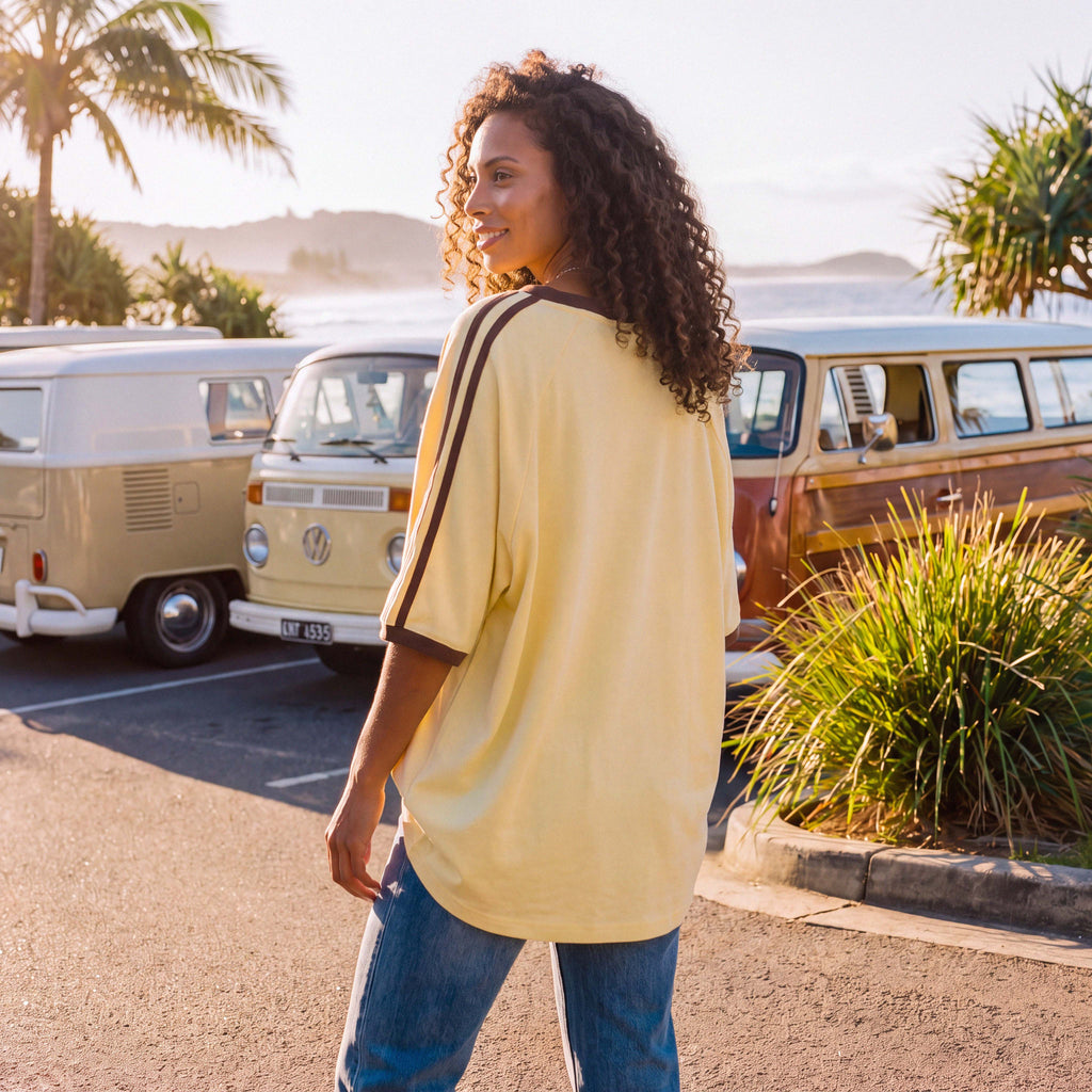 Close-up of the soft organic cotton jersey of the pale yellow ANNI tee – Oldest Daughter