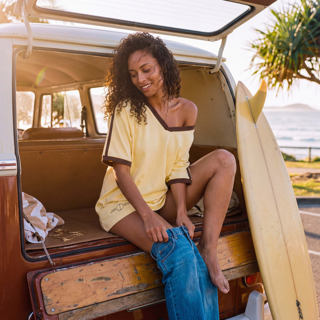 Model wearing the ANNI extra-oversized V-neck tee in pale yellow organic cotton – Oldest Daughter