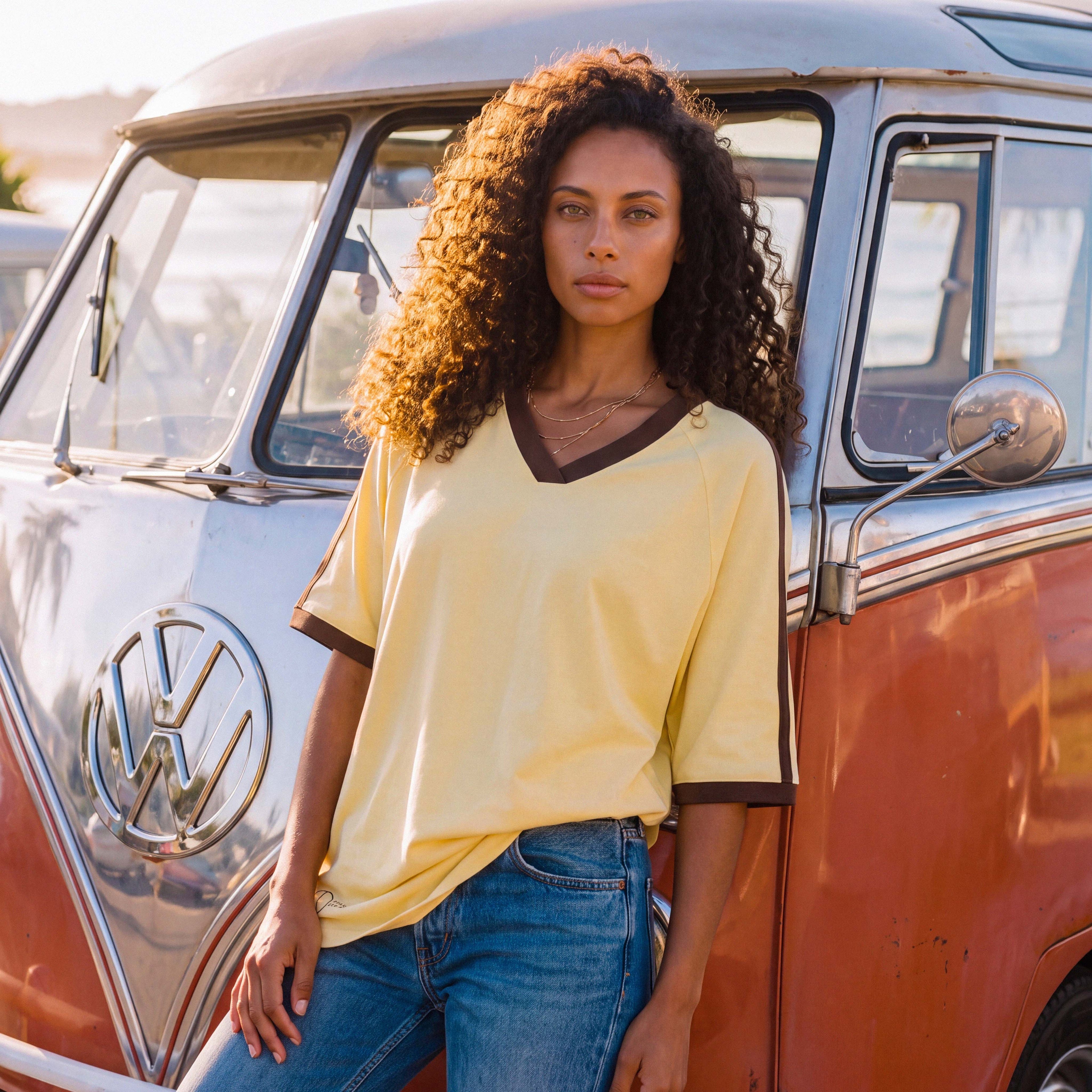 Half-length view of the pale yellow ANNI organic cotton V-neck tee – Oldest Daughter