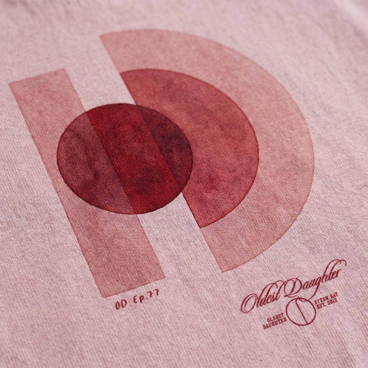 The One World O and D artwork by founder Arki printed on blush garment-dyed organic cotton – Oldest Daughter