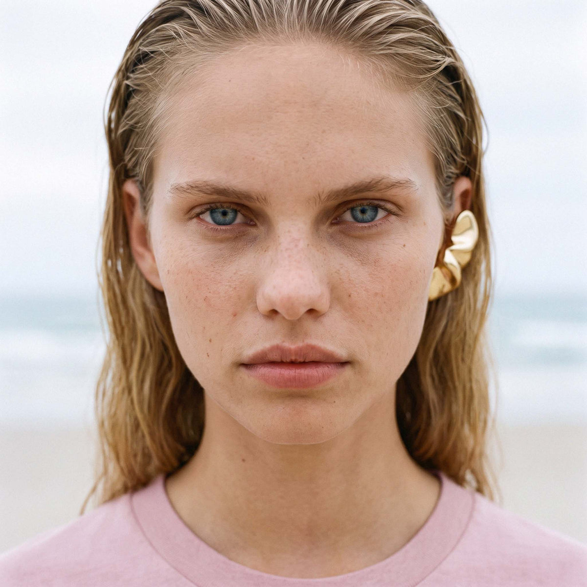 Close portrait showing the fine ribbed neckline of the blush AYLA organic cotton tee – Oldest Daughter, Byron Bay