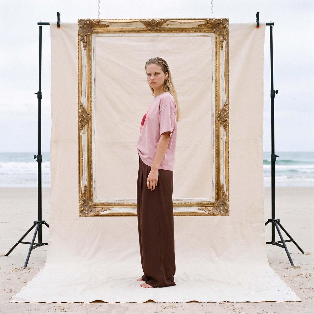 Side profile of the AYLA blush organic cotton boxy tee with wide-leg trousers – Oldest Daughter