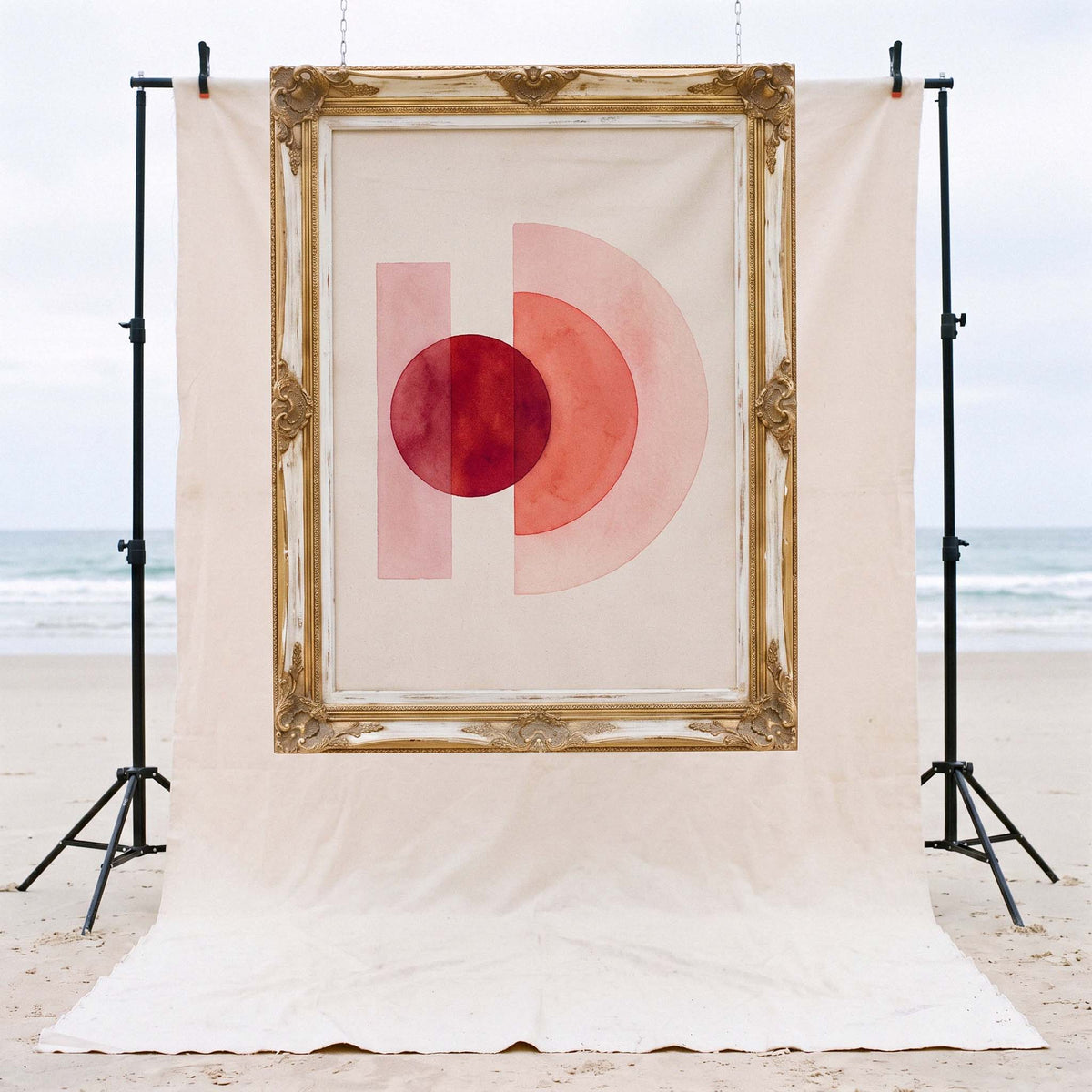 The original One World painting by founder Arki, hung in a gilt frame on the Byron Bay beach set – Oldest Daughter