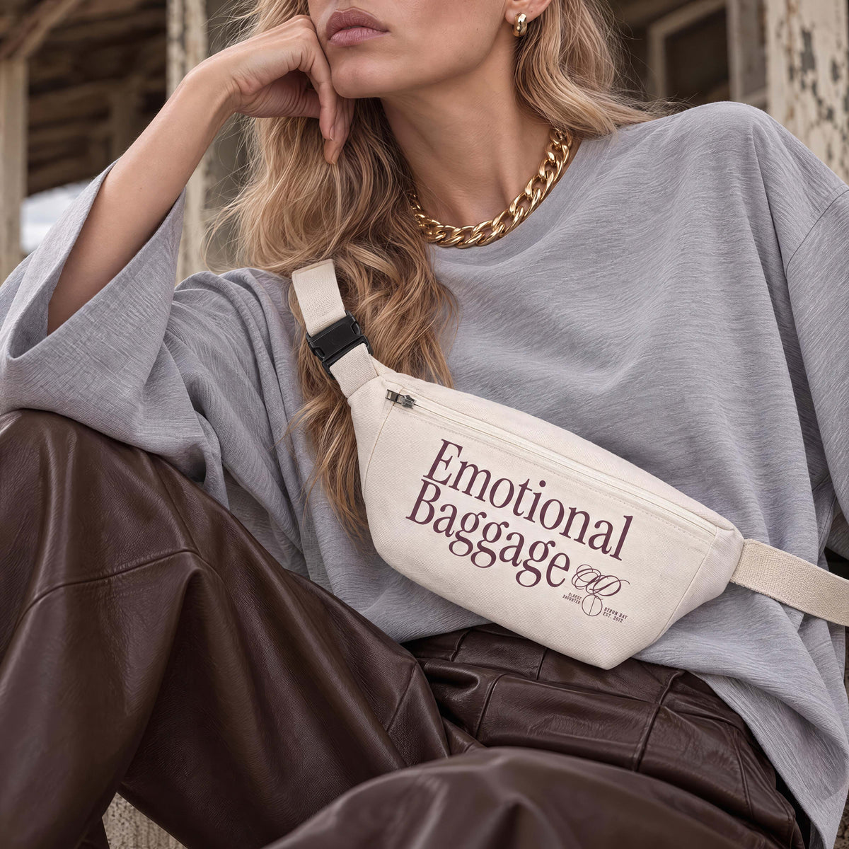 Cream recycled canvas hip bag printed with Emotional Baggage in plum, worn cross-body