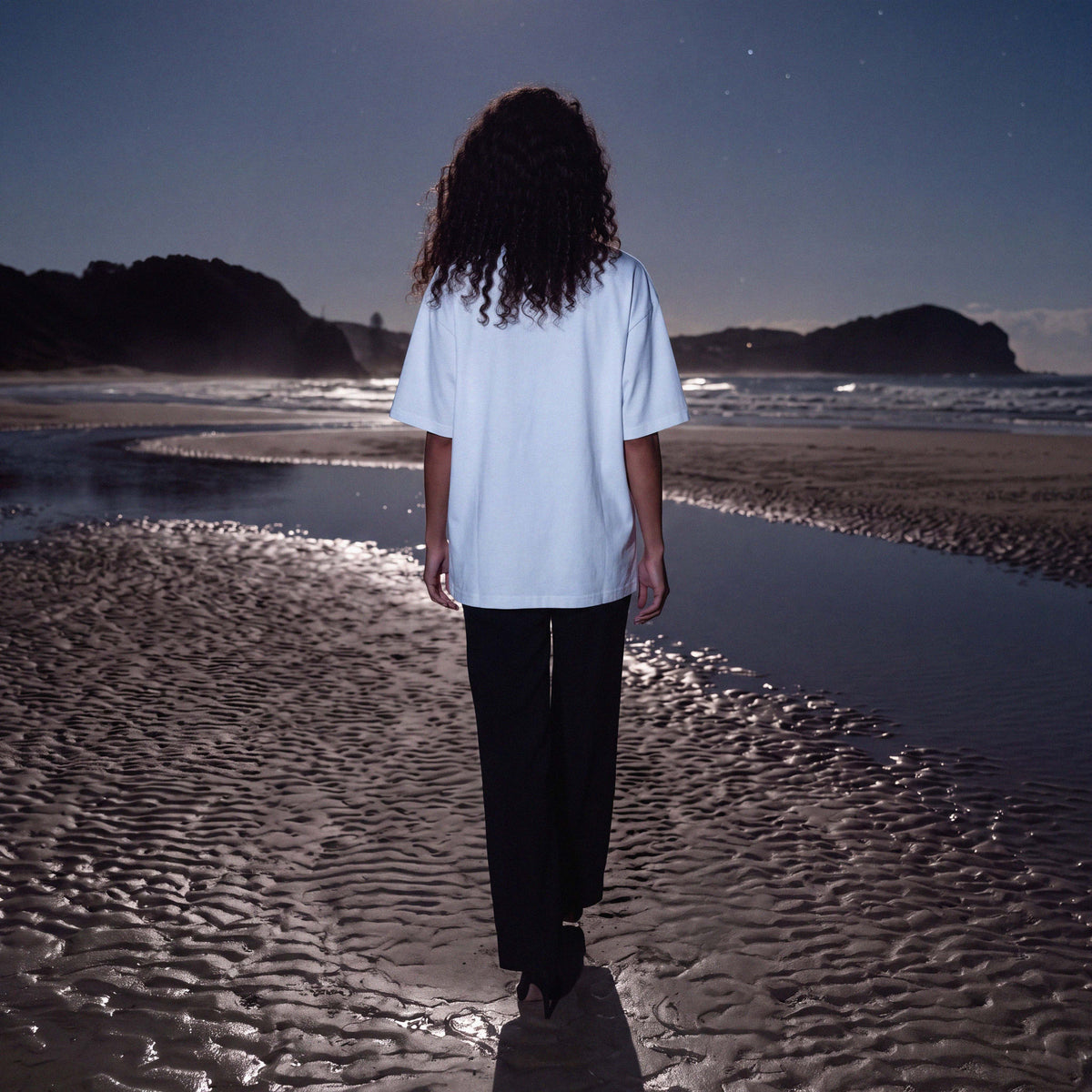 Full-length shot of a model in the CIARA white organic cotton oversized tee – Oldest Daughter