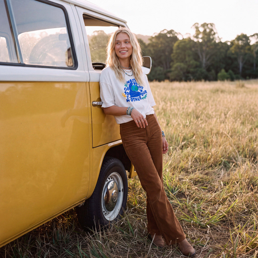 Full-length shot of a model in the cream KAIA organic cotton boyfriend tee – Oldest Daughter, Byron Bay