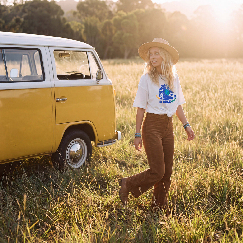 Model in the KAIA cream organic cotton tee in a golden grass field – Oldest Daughter, Byron Bay