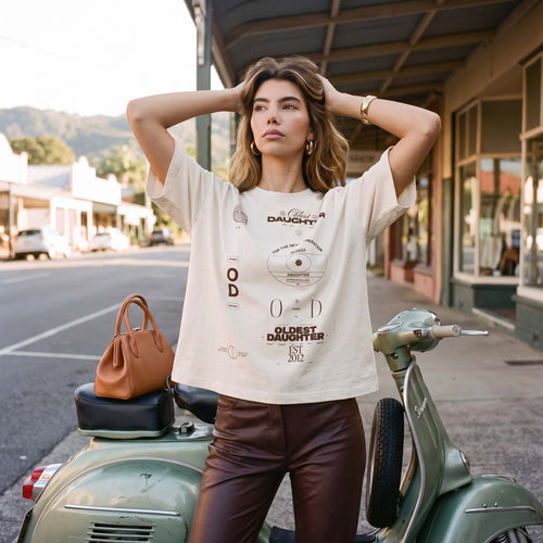 Model wearing the MACY undyed organic cotton boxy tee with tailored trousers – Oldest Daughter