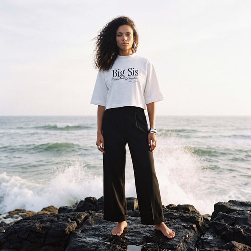 Model wearing the white RAYA cropped boxy tee with the Big Sis print – Oldest Daughter, Byron Bay