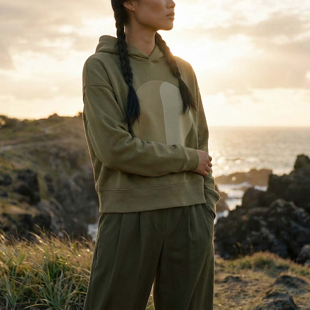 YARA oversized organic cotton hoodie in faded olive, worn by the coast – Oldest Daughter